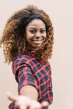 Young Cheerful Black Woman Reaching Out Hand