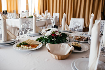 Beautiful tableware, flowers and candles decor decoration