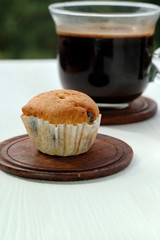 Muffin and a cup of coffee on a light background