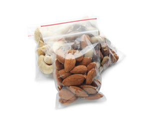 Zipper bags with different nuts on white background