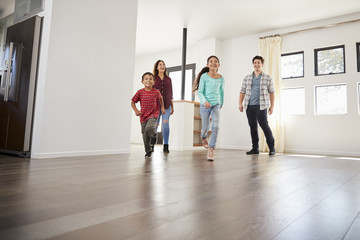 Excited Family Exploring New Home On Moving Day