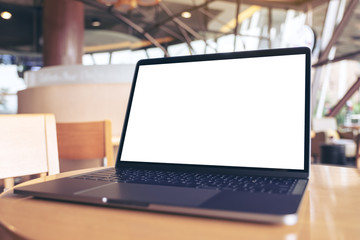 Mockup image of laptop with blank white desktop screen on wooden table in cafe
