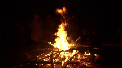 The group of people looks at big fire. Holiday.