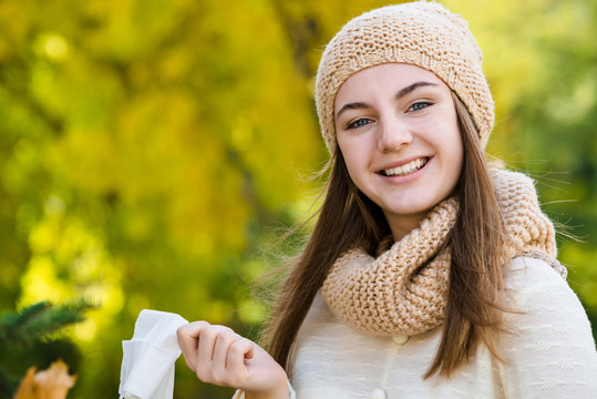 No ill no allergy. Woman throws out a handkerchief on autumn background