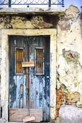 old wooden door on a ruined facade