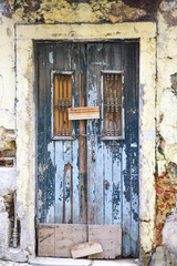 old wooden door on a ruined facade