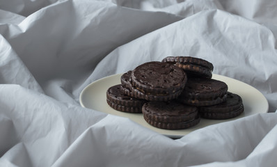 chocolate cookies on a white tablecloth