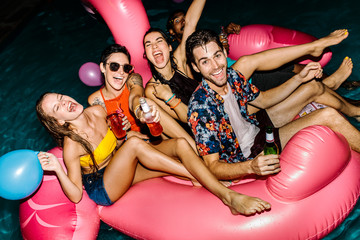Group of men and women enjoying at pool party