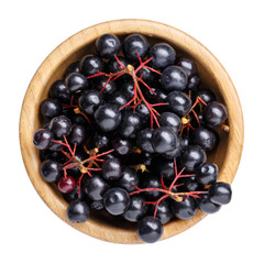 Black chokeberry berries ( Aronia melanocarpa ) in wooden bowl isolated on white