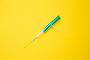 Medical syringe on colorful background.