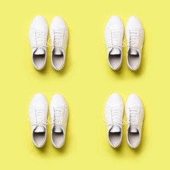 Stylish white sneakers and rope on yellow background with copy space. Top view. Square crop. Minimal flat lay. Summer shoes collection. First step concept