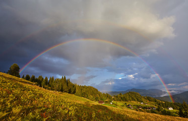 Mountain nature photo background with bright rainbow