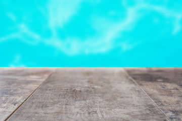 Wooden board empty and swimming pool bokeh background

