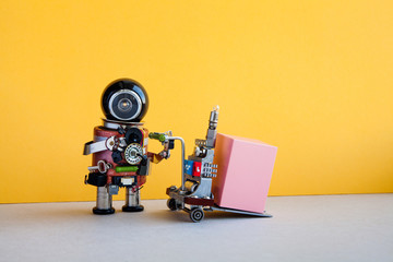 Robotic logistic delivery service concept. Robot courier with pink container on powered pallet jack. Forklift cart mechanism on yellow wall, gray floor background.