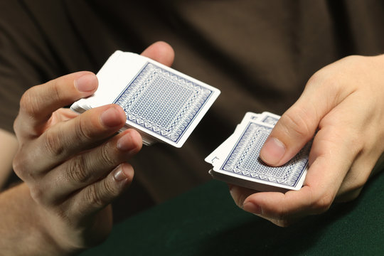 Person Shuffling a Deck of Cards