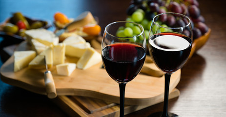 Two glasses of wine on the background of various appetizers