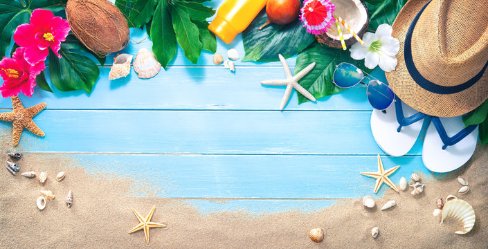 Straw hat with a exotic cocktail and sunglasses on sand beach