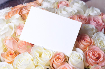Obraz na płótnie Canvas Flat lay stylish mockup photo with a blank greeting card and roses bouquet flowers. Feminine photo for blog and website.