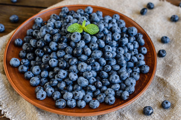 Fresh berries of blueberry on a plate. It can be used as a background