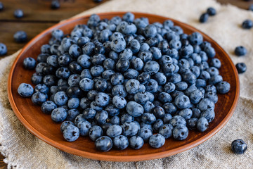 Fresh berries of blueberry on a plate. It can be used as a background