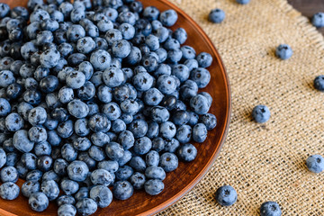 Fresh berries of blueberry on a plate. It can be used as a background