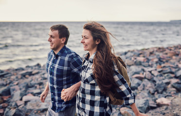 happy couple running near the lake