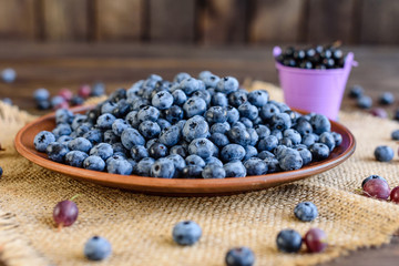 Fresh berries of blueberry on a plate. It can be used as a background