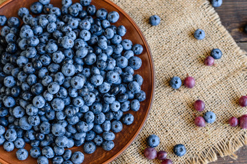 Fresh berries of blueberry on a plate. It can be used as a background