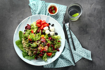 Plate with tasty quinoa salad on table