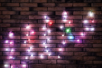Festive Christmas garland on brick wall