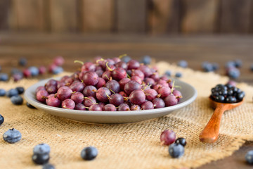 Fresh gooseberry on a plate. It can be used as a background