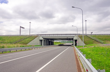 Highway asphalt road passes under the bridge of high-speed highway.