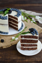 Beautiful tasty cake with white cream and berries of blueberry