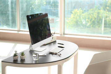Stylish workplace with computer on table in office