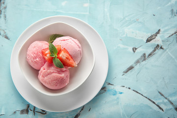 Bowl with delicious strawberry ice-cream on color background