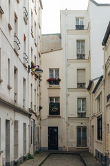 Fototapeta na wymiar Paris residential buildings. Old Paris architecture, beautiful facade, typical french houses on sunny day. Famous travel destinations in Europe. City life, lifestyle and expensive real estate concept