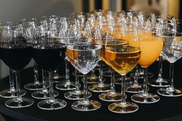 Many glasses of different bevereges