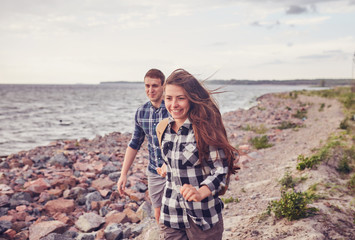 Fototapeta na wymiar happy couple running near the lake