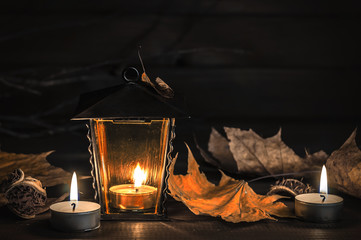 old lantern, autumn leaves on a wooden table
