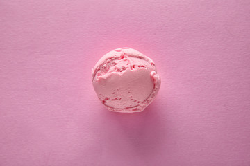 Strawberry ice cream ball on color background