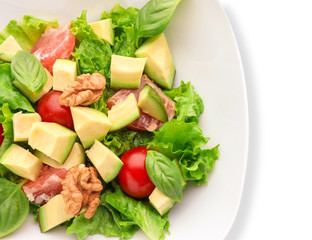 Plate with tasty avocado salad on white background