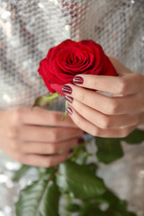 Young woman with beautiful manicure and rose, closeup