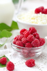 Fresh raspberry in a bowl and dairy product for breakfast