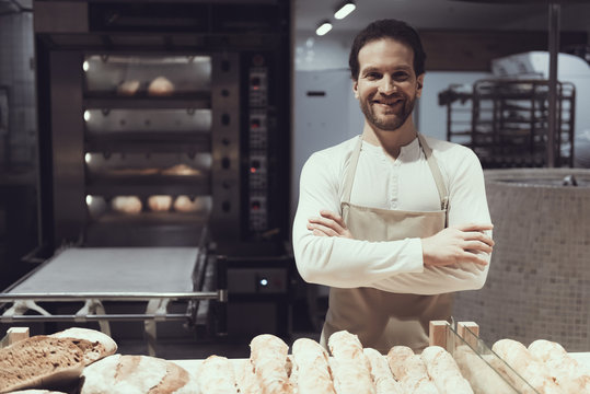 Smiling Baker in Bakery Department in Supermarket.
