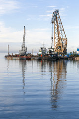 Floating cranes loaded goods on the water