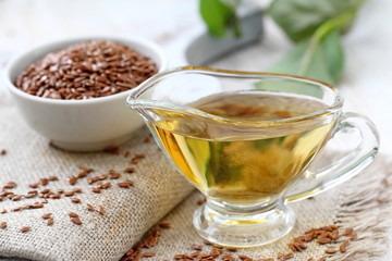 Linseed oil in glass and linen seeds
