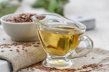 Linseed oil in glass and linen seeds