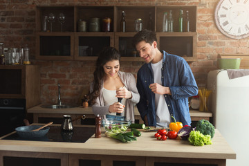 Happy couple cooking healthy food together