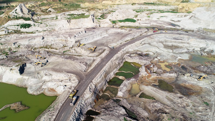 Aerial view on open pit mine of sand, hummus and coal, flooded with water