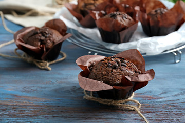 Tasty chocolate muffin on wooden table